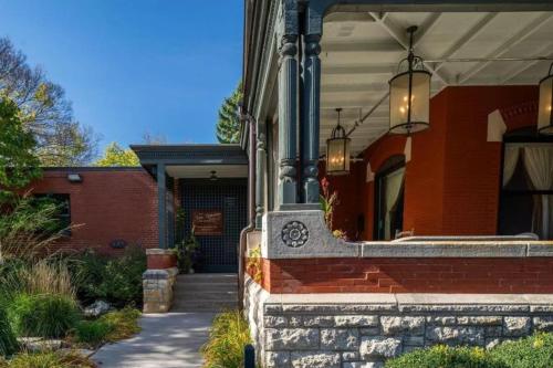 a brick house with two lights on the front of it at The New Victorian Mansion Bed & Breakfast in Saint Paul