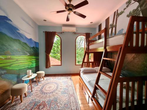 a bedroom with bunk beds and a ceiling fan at Wonderful Villa Felice in Yogyakarta