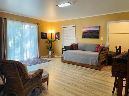 a bedroom with a bed and a large window at The Groves at Redway Beach - Studio in Redway