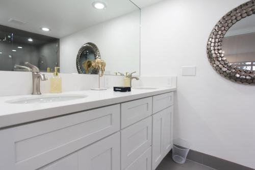 a white bathroom with a sink and a mirror at LVC0615 - Lake Therapy condo in Zephyr Cove