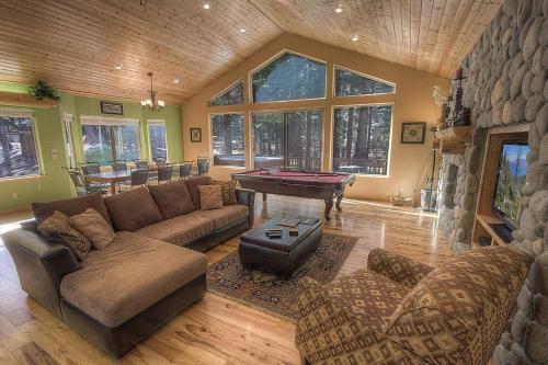 a living room with a couch and a pool table at COH1669 - Hawk's View Hideaway home in South Lake Tahoe
