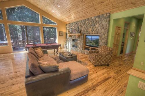 a living room with a couch and a pool table at COH1669 - Hawk's View Hideaway home in South Lake Tahoe
