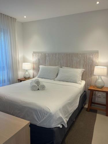 a bedroom with a bed with two towels on it at Céu do Morro in Morro de São Paulo