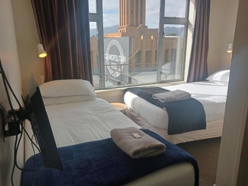 Postel nebo postele na pokoji v ubytování Cosmopolitan Hotel
