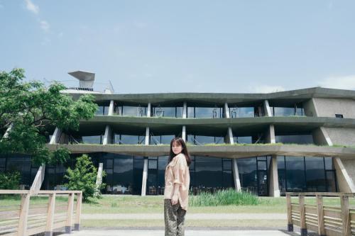 a woman standing in front of a building at Setre Marina Biwako in Moriyama