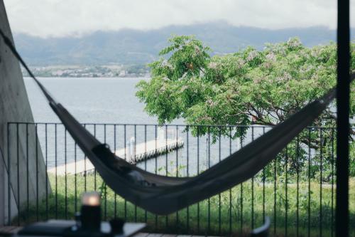 a hammock on a balcony overlooking a body of water at Setre Marina Biwako in Moriyama
