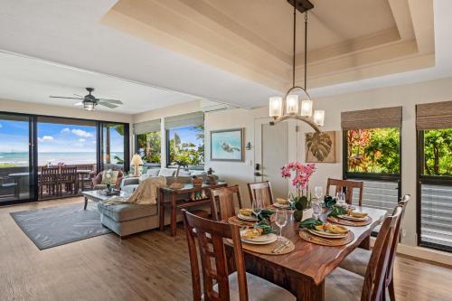 a dining room and living room with a table and chairs at Kahana Village 36 · KHV 36 Oceanfront 3BD Kahana Condo, Beach & in Lahaina