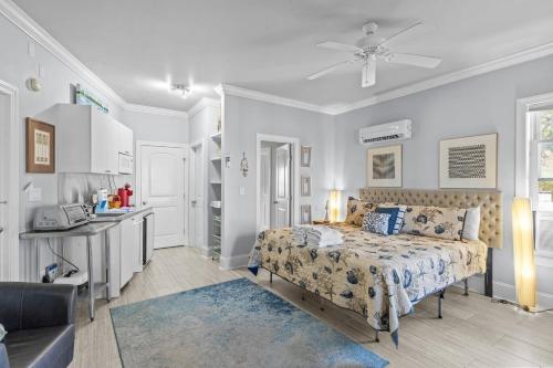 a bedroom with a bed and a table and a kitchen at Bridgeview on Broad home in Beaufort