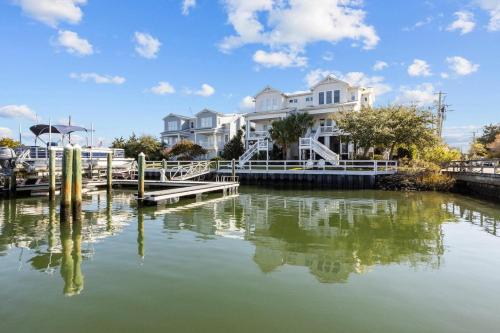 a large white house with a dock in the water at Bridgeview on Broad home in Beaufort