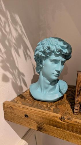 a statue of a bust on a wooden shelf at Stylish Condo on Victorian Seafront, Voyagers Rest Bexhill in Bexhill