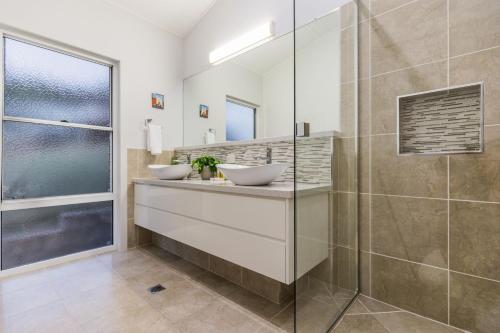a bathroom with two sinks and a shower at Slipaway 1770 in Seventeen Seventy