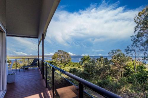 a balcony of a house with a view of the ocean at Slipaway 1770 in Seventeen Seventy