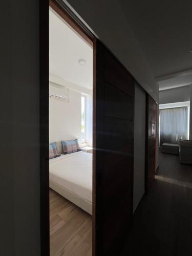 a bedroom with a bed and a window at Bavaro Punta Cana Beach pool ducassi sol caribe Los corales in Punta Cana