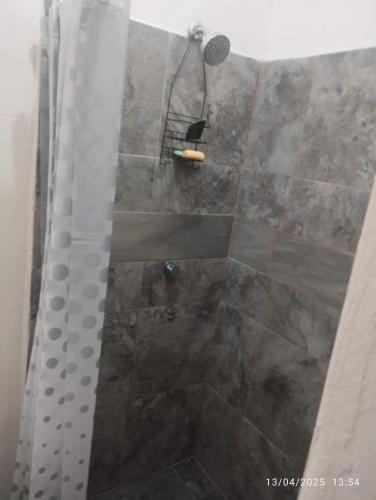 a shower with a glass door and a shower at Depa in Mazatlán