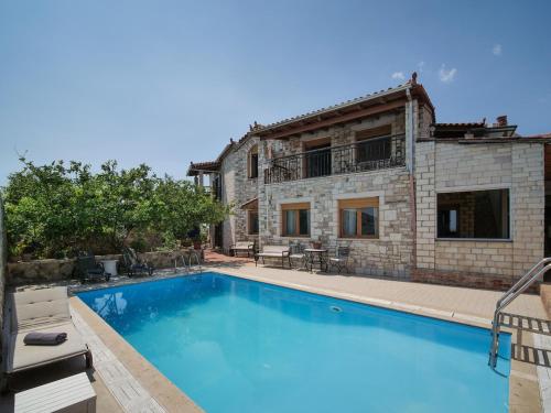 a large swimming pool in front of a house at Ionian Manor Estate 2 in Palermo