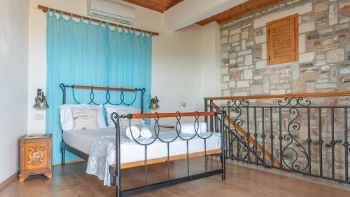 a bedroom with a bed and a stone wall at Ionian Manor Estate 2 in Palermo