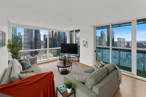 a living room with a view of a city at Nook Melbourne Apartments : Jane Bell Lane - Melbourne CBD in Melbourne