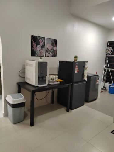 a office with a desk with a computer on it at Ana Homestay in Seri Manjung