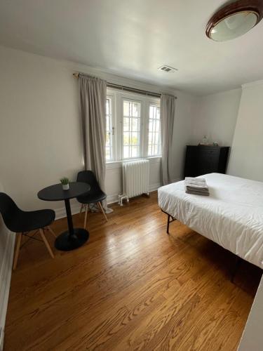 a bedroom with a bed and a table and a window at The Ambassador in Ottawa