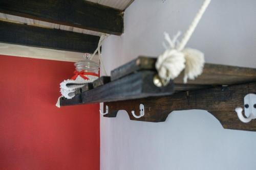 a wooden shelf with a pair of shoes on it at Wenu Ruka in El Bolsón