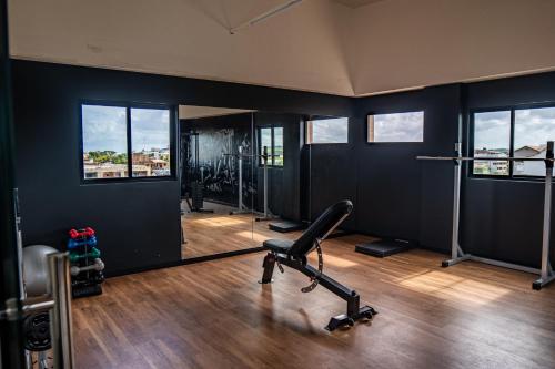 a gym with a treadmill and a mirror at Easy Porto Hotel in Porto De Galinhas