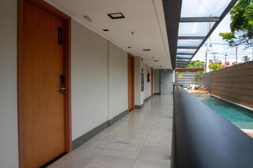 an empty corridor of a building with a swimming pool at Easy Porto Hotel in Porto De Galinhas