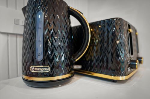 two black and gold coffee mugs sitting on a counter at Gorgeous 4 Bedroom House - Blackmans Bay in Kingston Beach