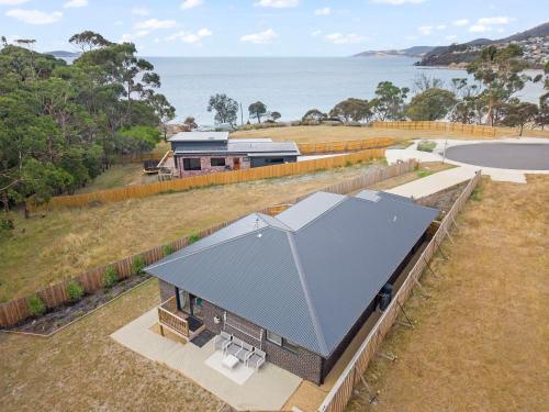 an overhead view of a building with a gray roof at Gorgeous 4 Bedroom House - Blackmans Bay in Kingston Beach