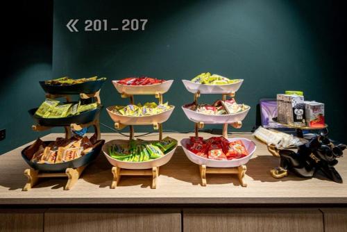 a display of fruits and vegetables in bowls on a table at Brown Dot Hotel South Gumi in Yangji-mal