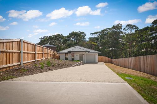 a driveway leading to a house with a fence at Gorgeous 4 Bedroom House - Blackmans Bay in Kingston Beach