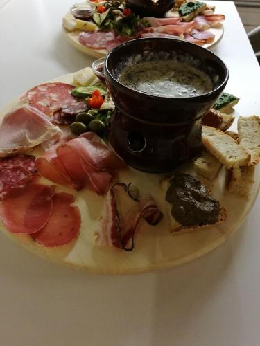a plate of food with meat and vegetables on a table at Tuscany - Romantic Getaway in Montecatini Val di Cecina