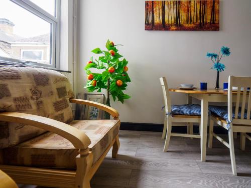 a living room with a christmas tree and a table at Chatham Lodge Family Room 2 Ensuite in Stoke on Trent