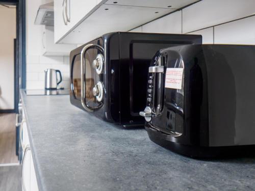 two toaster ovens on a counter in a kitchen at Chatham Lodge Family Room 2 Ensuite in Stoke on Trent