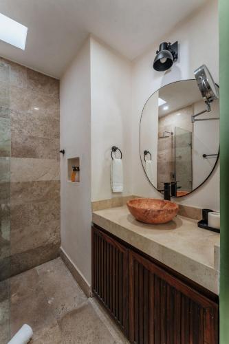 a bathroom with a sink and a mirror at Casa Mara 53 Luxury House in downtown Mérida in Mérida