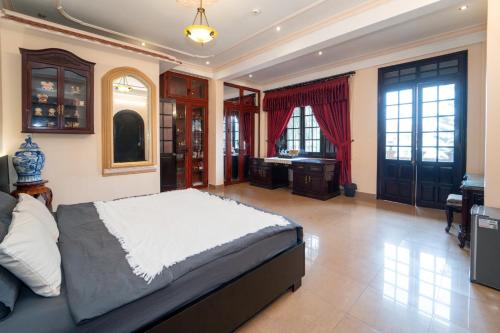 a large bedroom with a bed and a bathroom at Perfume Homestay Huế in Hue