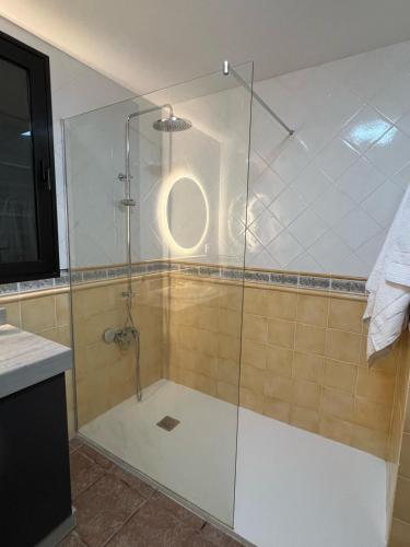 a shower with a glass door in a bathroom at Casona IROKO in La Costa