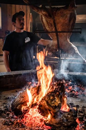 a man standing in front of a bon fire at Hotel del Paine in Torres del Paine