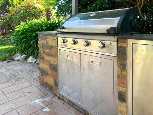 a barbecue grill sitting on top of a patio at Ocean Breeze - Sleeps 12 - Pet Friendly in Scamander