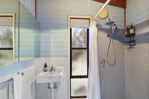 a bathroom with a sink and a shower at Ocean Breeze - Sleeps 12 - Pet Friendly in Scamander