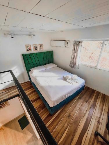 a small room with a bed in a boat at CASA LOMA BEACH LOFT in Taganga