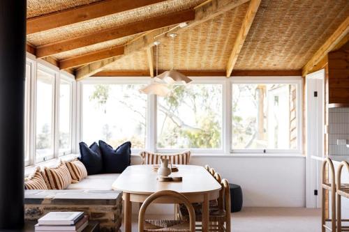 a living room with a couch and a table at Coastal Tree House- Short Stroll to Beach in Encounter Bay