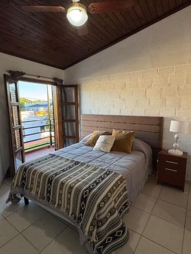 a bedroom with a bed and a large window at Victoria Apart in Esquina