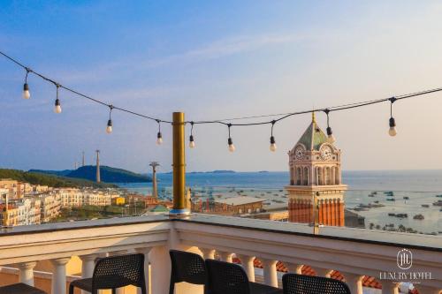 a view of a building with a clock tower at Luxury Sunset Town Hotel Phu Quoc in Phu Quoc