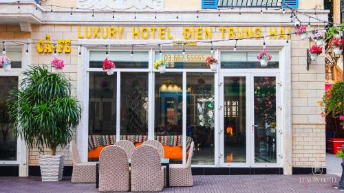 a store front with chairs in front of a building at Luxury Sunset Town Hotel Phu Quoc in Phu Quoc
