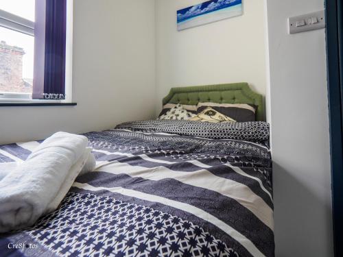 two beds sitting next to each other in a bedroom at Chatham Lodge Double Room 3 Ensuite in Stoke on Trent