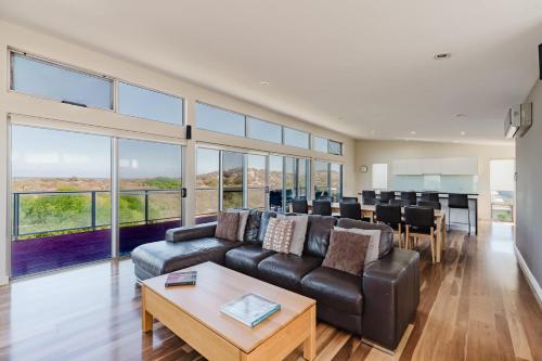a living room with a couch and a table at Bradford Shores Goolwa - Luxury - Wi-Fi - No Linen Included in Goolwa