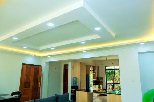 a living room with a coffered ceiling with at Stylish 3-bed Ensuite Apt in Westlands in Nairobi