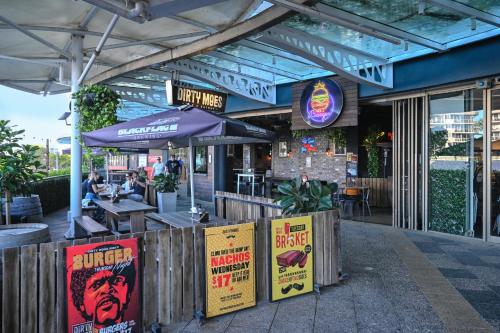 a restaurant with posters on the outside of it at Aegean Dream Mooloolaba Escape in Mooloolaba