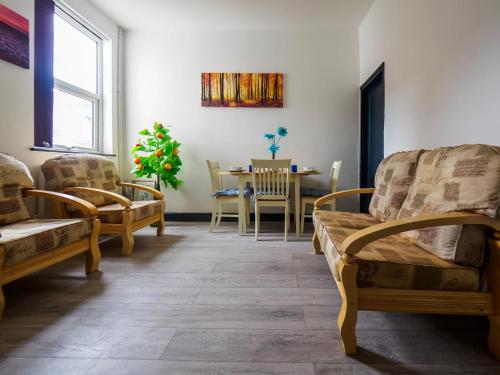 a living room with chairs and a table at Chatham Lodge Double Room 4 in Stoke on Trent