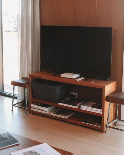 a flat screen tv sitting on a wooden entertainment center at Apple Valley West - Mahana in Mahana